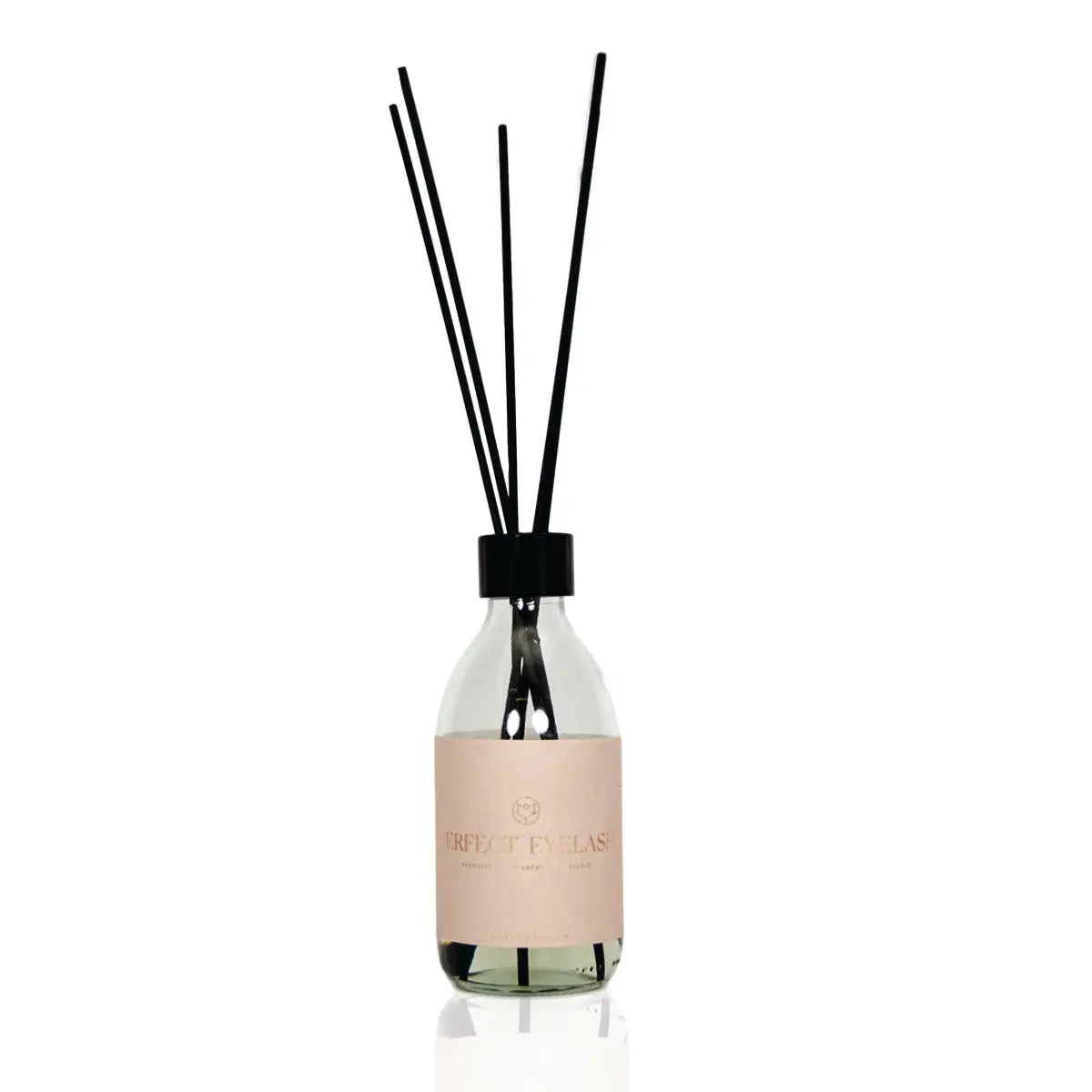 Fragrance sticks with black reeds in a glass bottle, offering a white flower and fig scent for home or salon use.